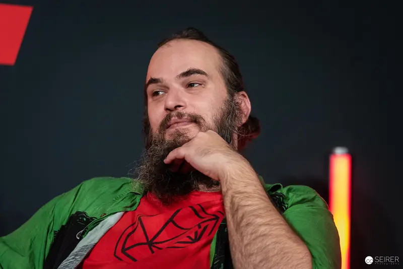 Bearded Attendee in Green Jacket at Vienna ComicCon 2024
