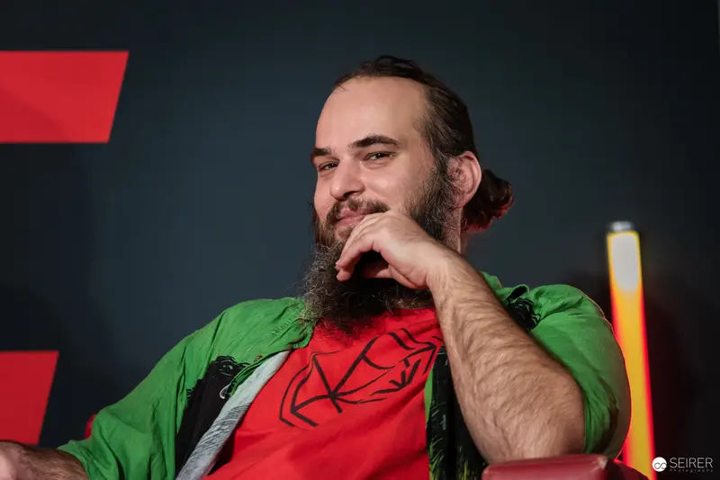 Bearded Performer in Green Jacket at Vienna ComicCon 2024