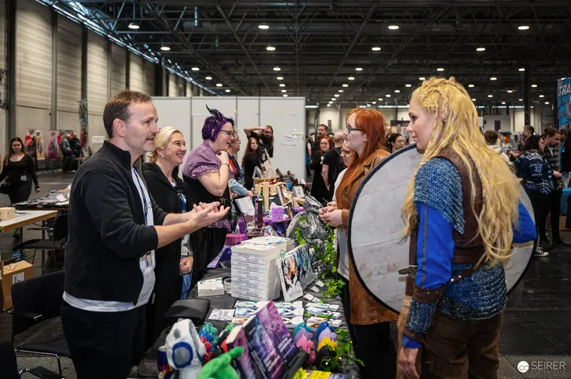 Cosplay Enthusiasts Interact at Vienna ComicCon 2024 Merchandise Booth
