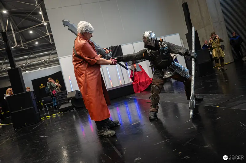 Cosplay Combat at Vienna ComicCon 2024: Dramatic Confrontation in Orange and Armor