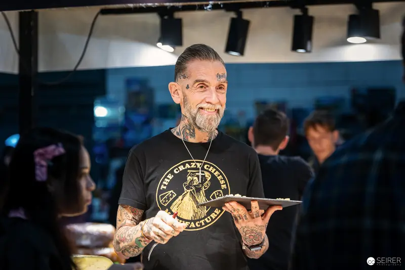 Tattooed Artist Showcasing Work at Vienna Event