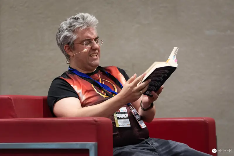 Comic Con Enthusiast Reading Book During VIECC 2024 in Vienna