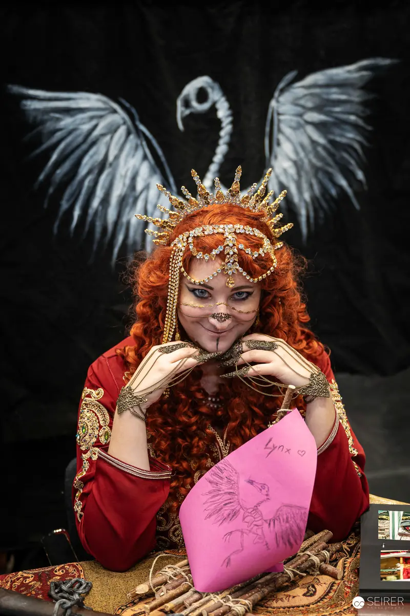 Cosplayer in Elaborate Red Costume with Fantasy Wings at Vienna ComicCon 2024