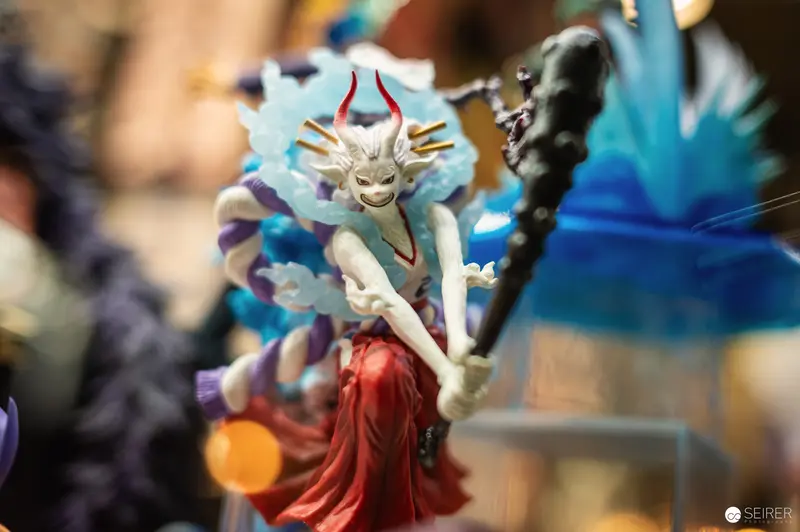 Intricate Fantasy Figurine with Horned Creature at Collector's Exhibition