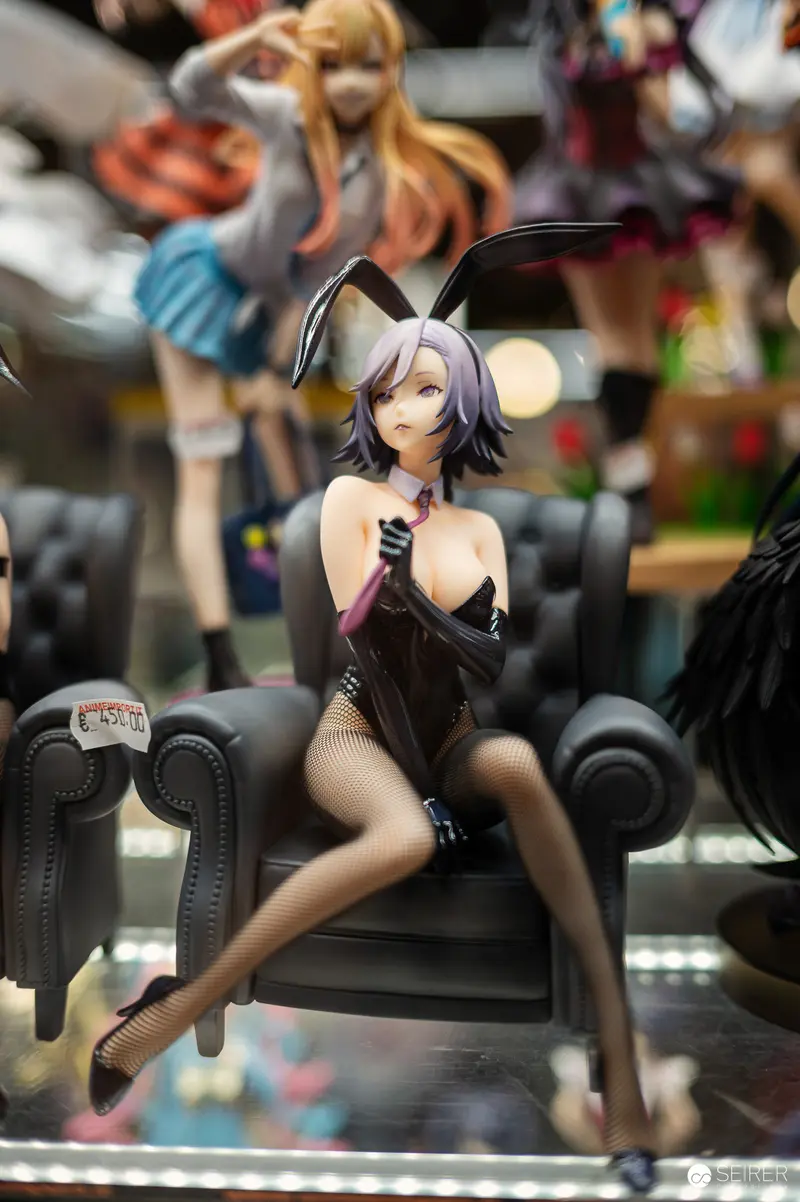 Anime Figurine of Bunny Girl Seated on Miniature Leather Chair at Collectible Display