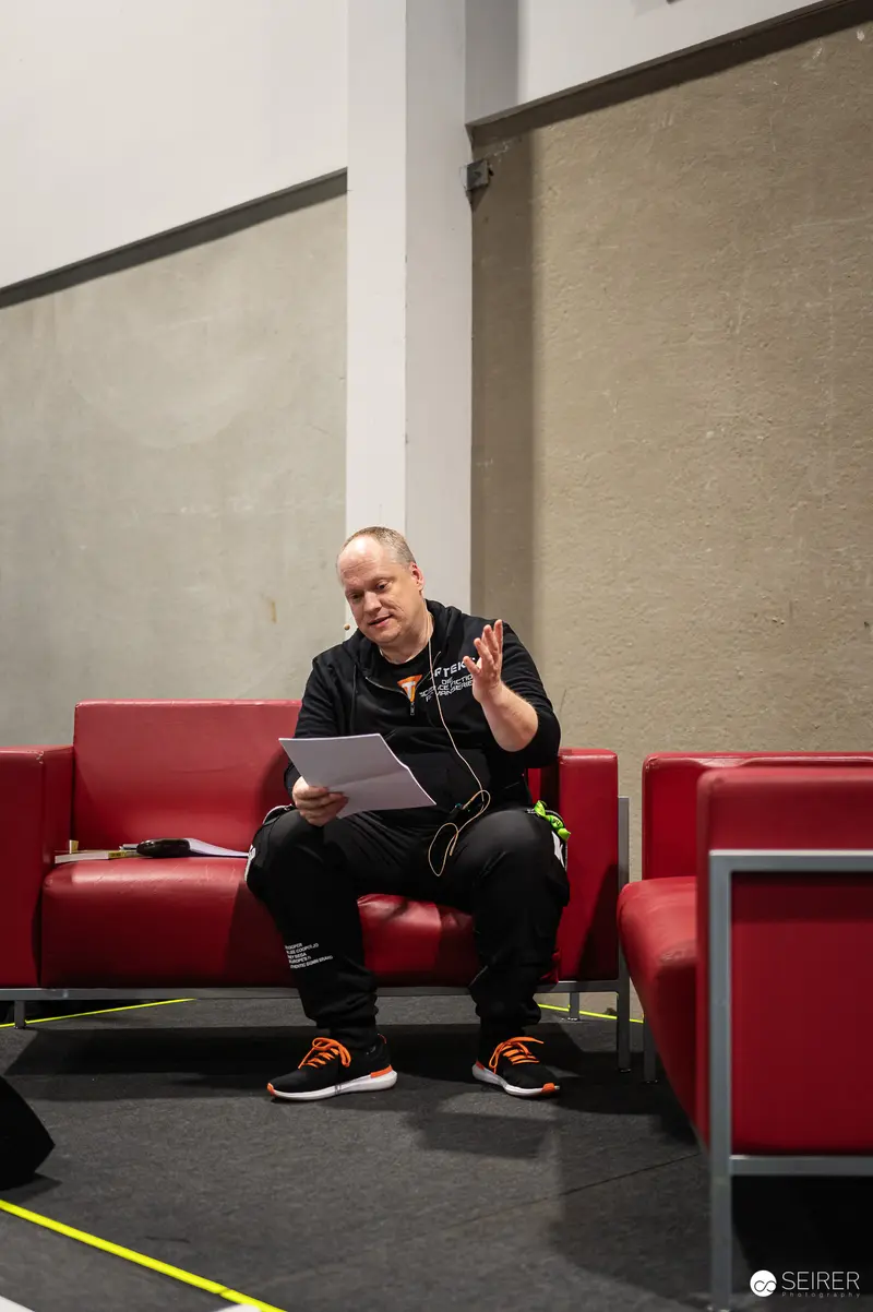 Intense Moment at Vienna ComicCon 2024: Participant on Red Sofa