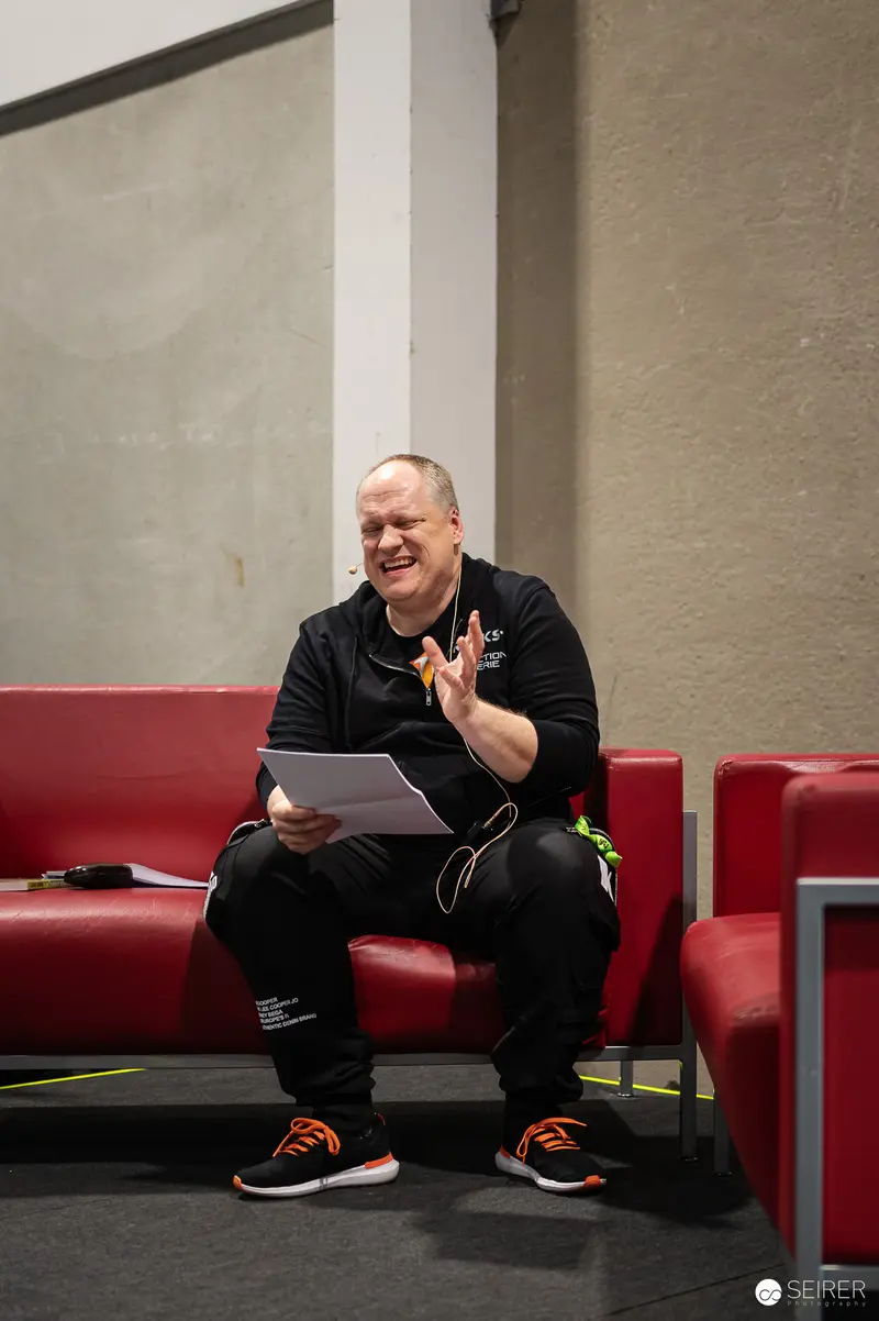 Smiling Participant Reading Backstage at Vienna ComicCon 2024