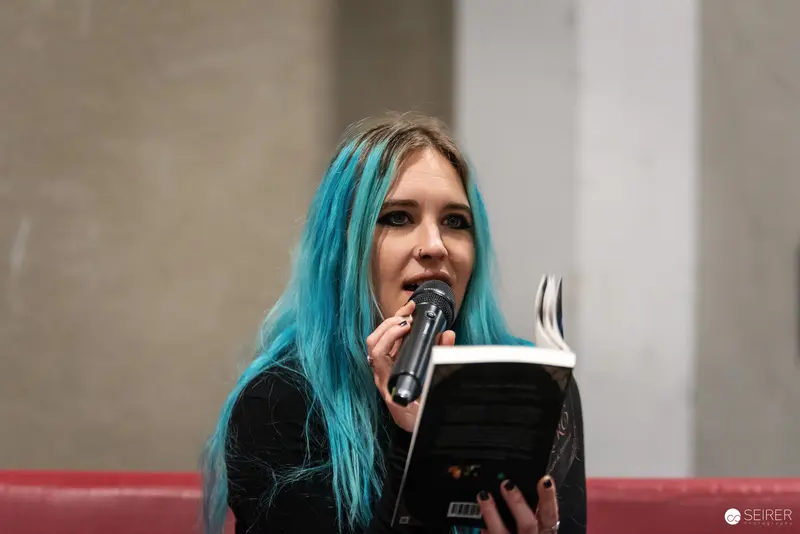 Blue-Haired Performer Reading at Vienna ComicCon 2024