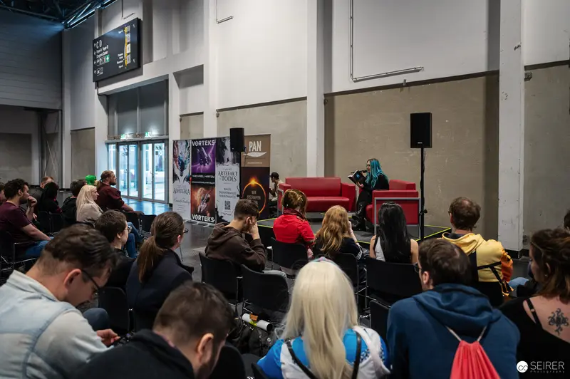 Audience at Vienna ComicCon 2024 Convention Listening to Panel Presentation