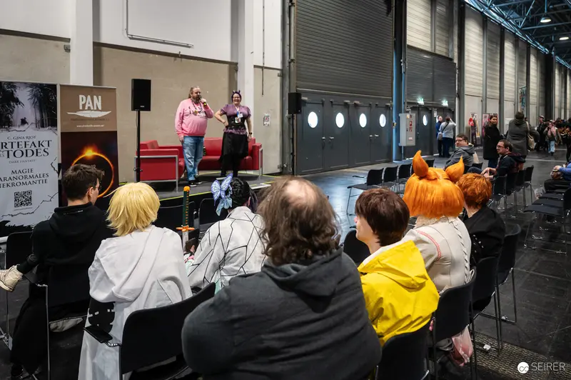 Two Presenters on Stage at Vienna ComicCon 2024 Convention