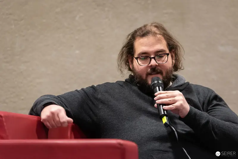 Bearded Speaker with Microphone at Vienna Event