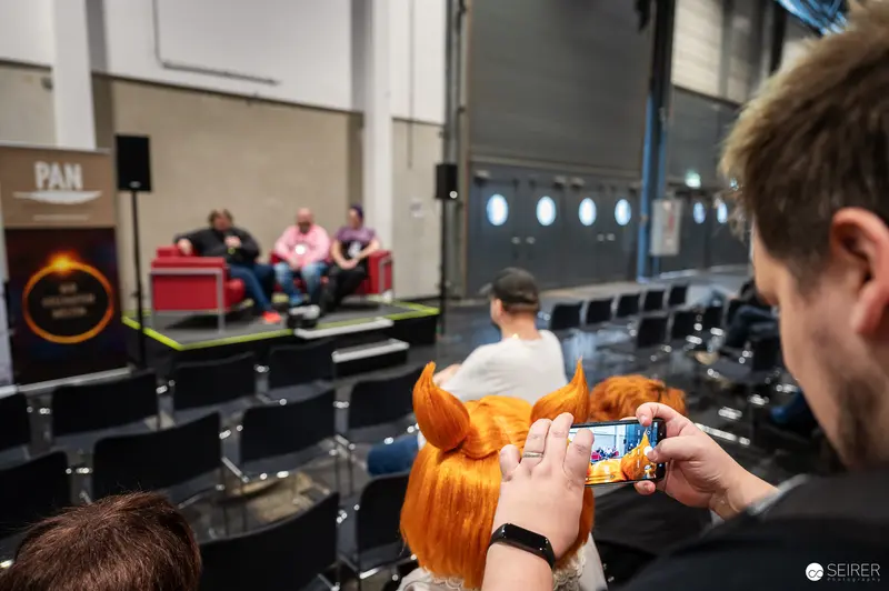 Vienna ComicCon 2024: Attendee Capturing Event Moment with Smartphone Camera