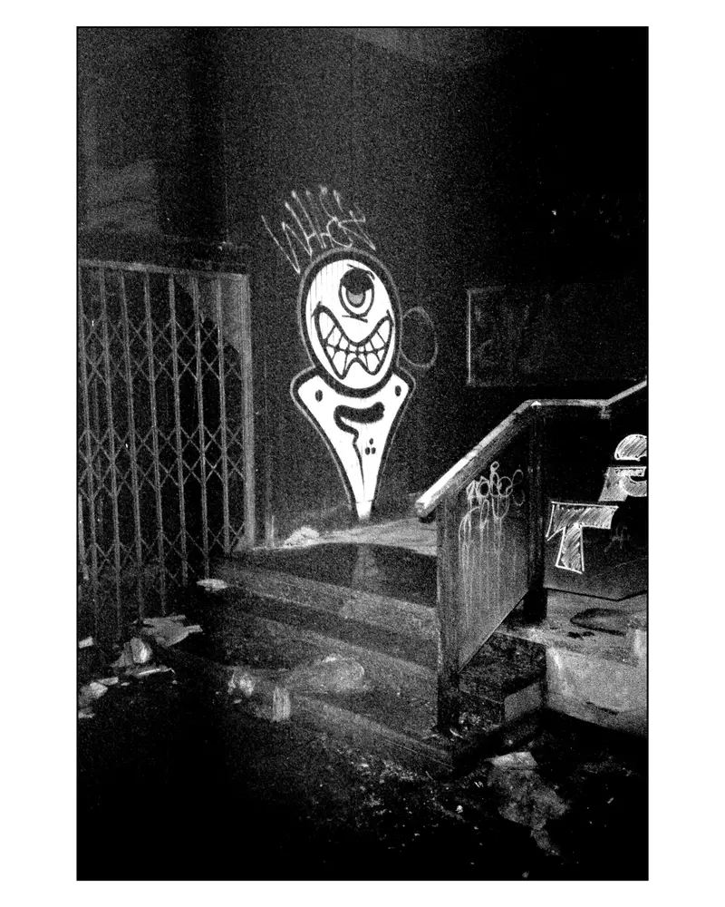 One-eyed monster graffiti on stairwell wall in Grado, Italy