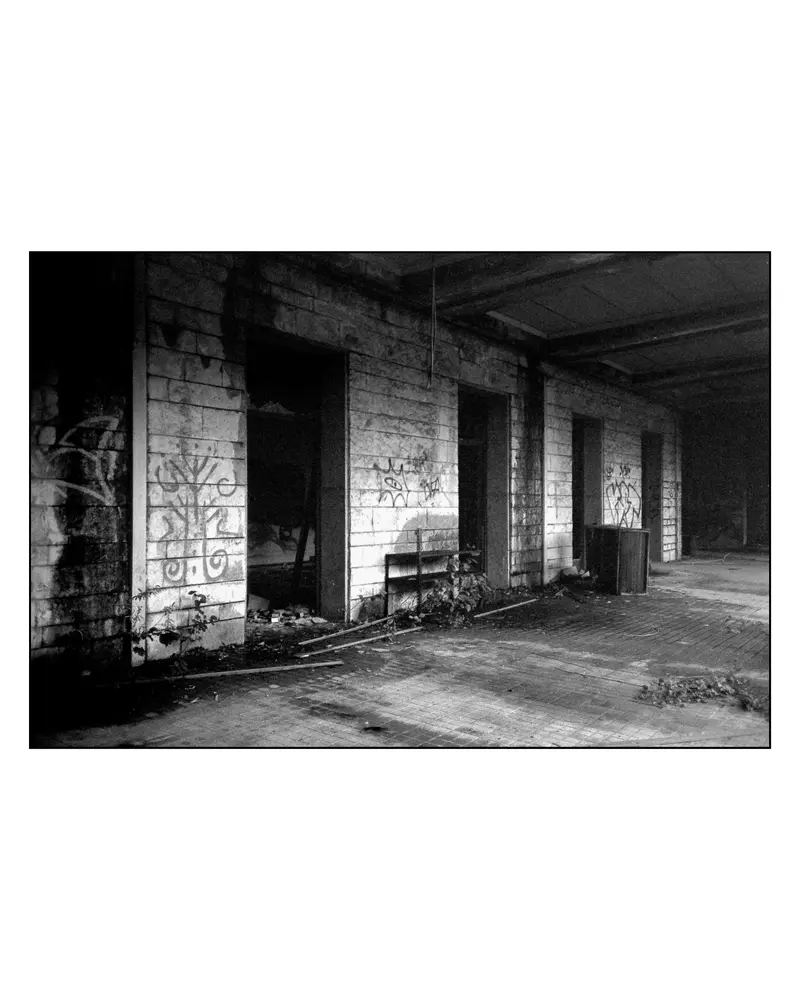 Graffiti-covered arcade of an abandoned building on the Villach–Grado route, 2024