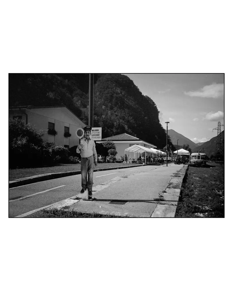 Cardboard police officer with "Rallenta! Slow Down!" sign on Alpe-Adria cycle path, Italy