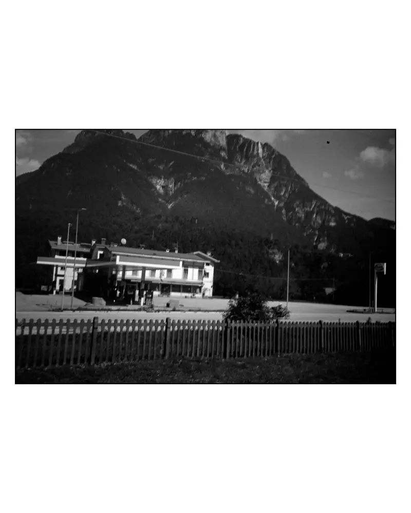 Roadside filling station below limestone peak on the Villach–Grado cycling route, 2024