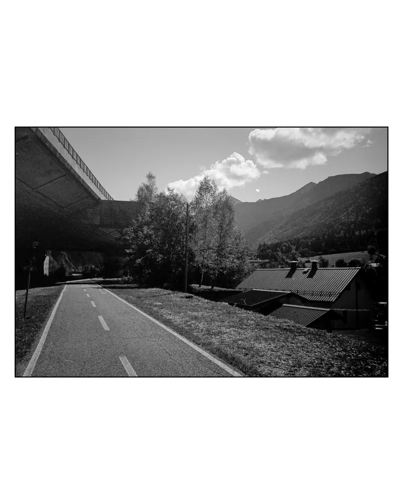Alpe-Adria cycle path beneath motorway viaduct in Alpine valley, Villach–Grado tour 2024