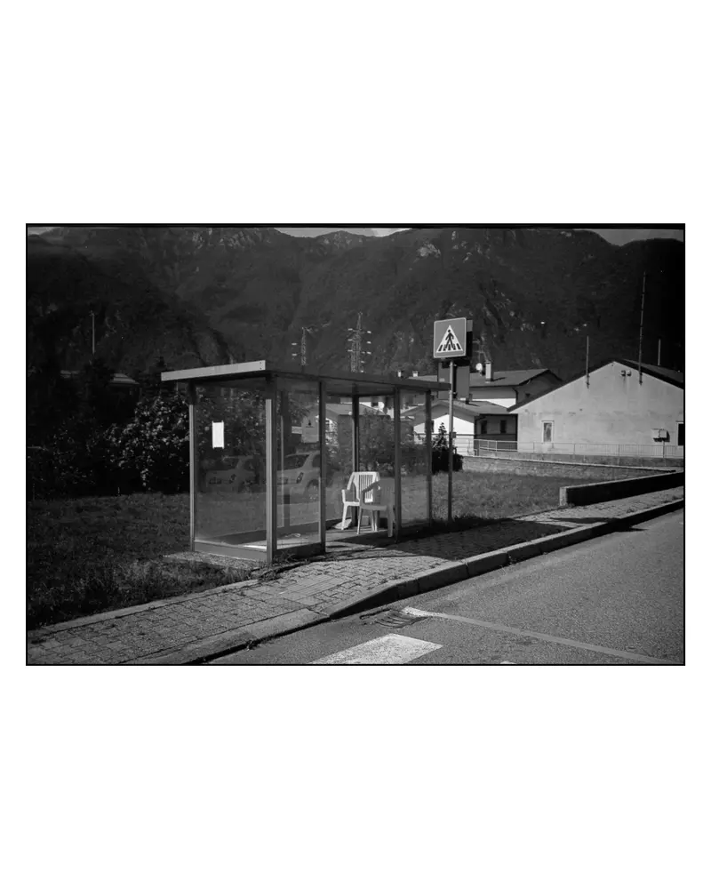 Glass Bus Shelter with Plastic Chair on Alpine Roadside, Villach–Grado Route, 2024
