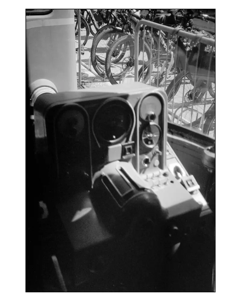 Train driver's cab controls beside packed bicycle parking, Villach–Grado cycling trip 2024