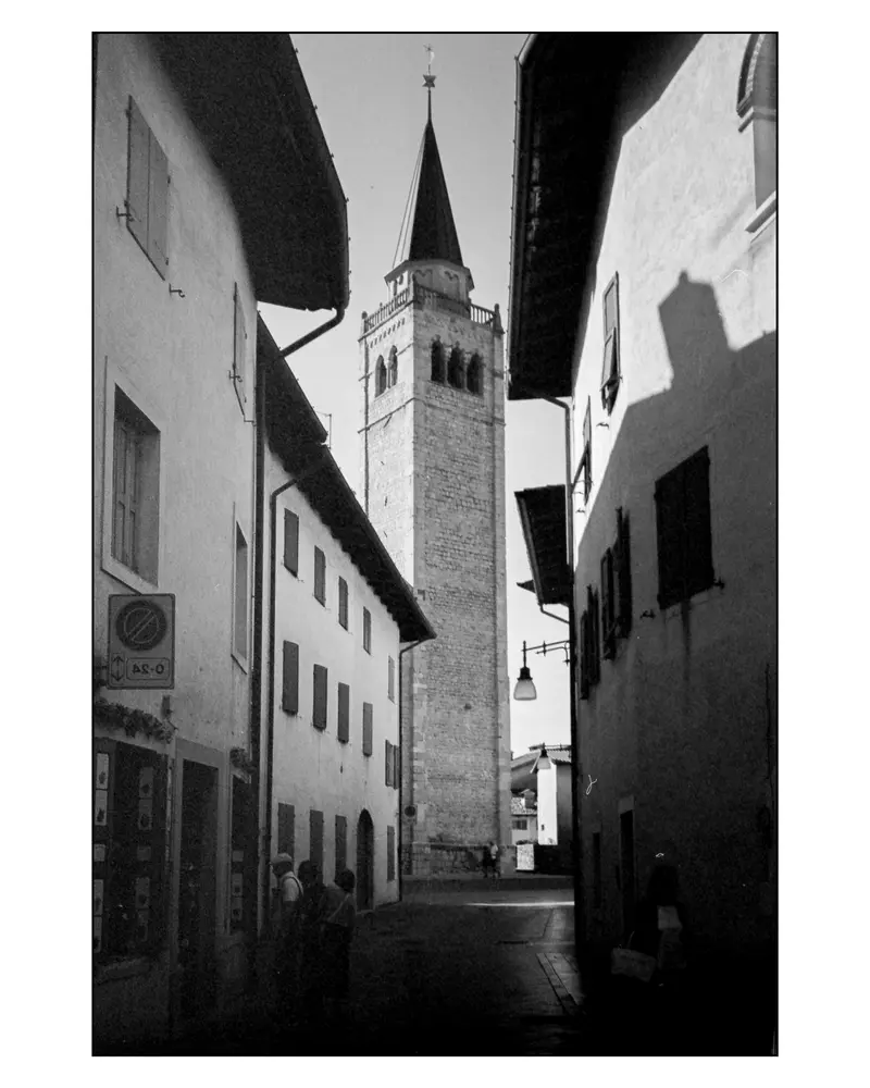 Stone Bell Tower Framed by Narrow Alley, Northern Italian Town, Villach–Grado Route 2024
