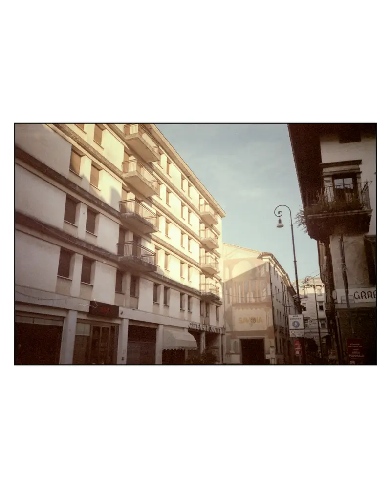 Cinema Savoia facade and balconied apartment block on a Grado street, September 2023