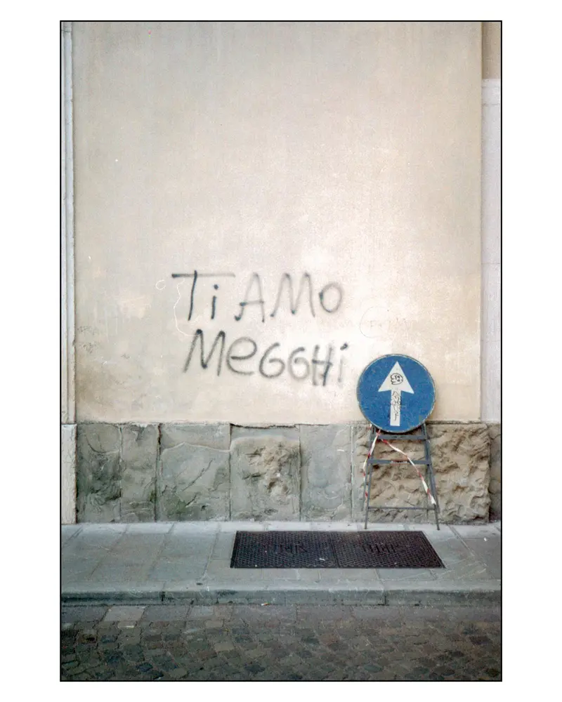 "Ti Amo Meggi" Graffiti and Blue Arrow Sign on Grado Street Wall