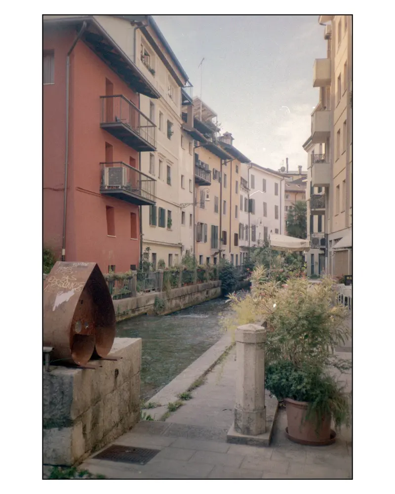 Rusted Corten Sculpture Beside Narrow Canal in Grado Old Town, Italy