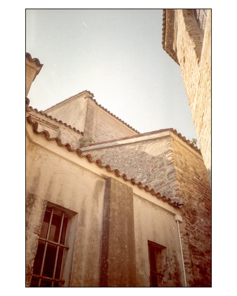 Terracotta-tiled rooflines and stone walls in Grado's historic old town, 2023