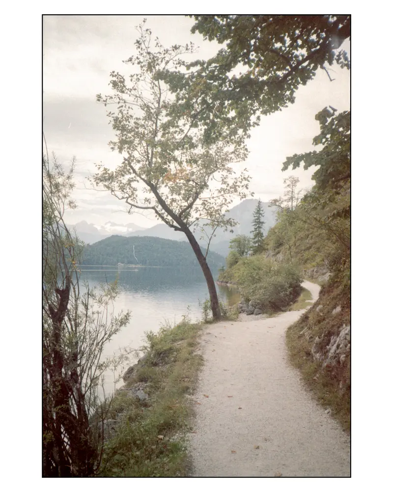 Gravel lakeside footpath along an alpine lake on the Villach–Grado route