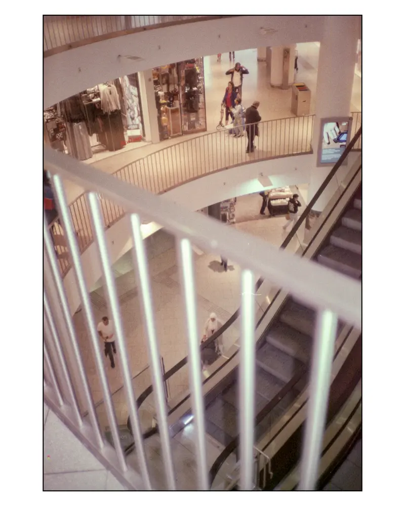 Shoppers on Curved Balconies of Multi-Level Mall, Villach–Grado Trip 2024
