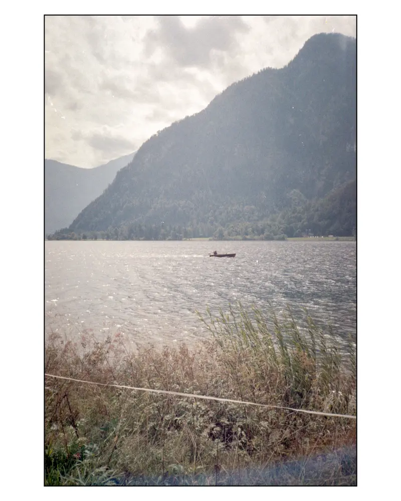 Lone rowing boat on an Alpine lake near Villach, Carinthia, Austria