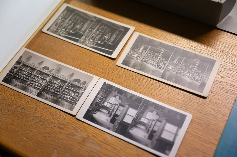 Vintage Black and White Photographs Displayed on Wooden Surface