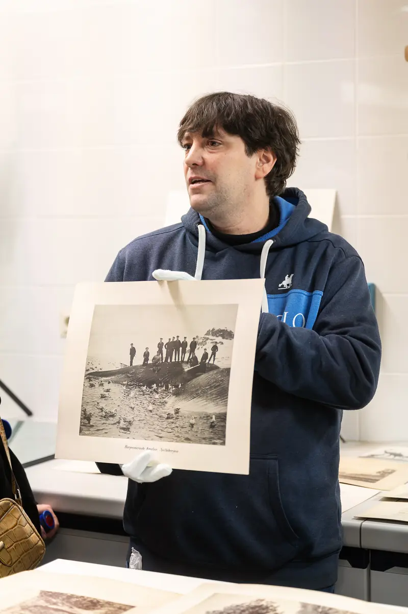 NHM Curator Examining Archival Photograph During Foto Arsenal Wien Exhibition Tour