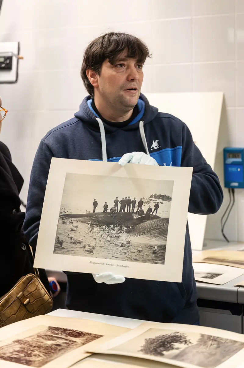 Naturhistorisches Museum Wien Curator Displays Archival Photograph During Foto Arsenal Wien Exhibition