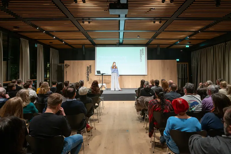 Conference Presenter Speaking at Design Event in Modern Venue