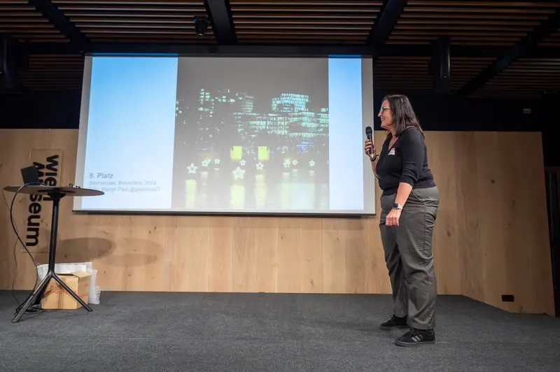 Speaker Presenting Urban Night Cityscape at Professional Conference
