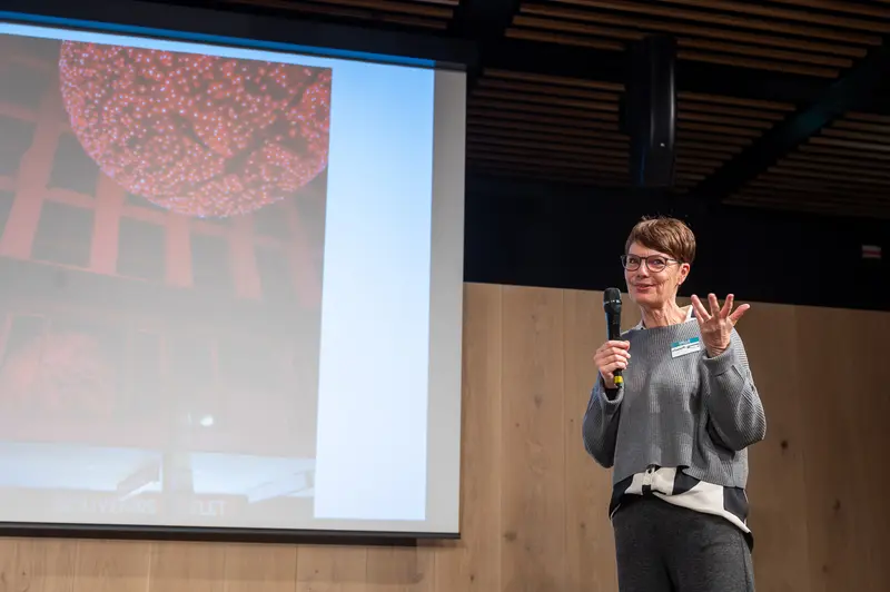 Speaker Presenting Scientific Research During Conference Presentation