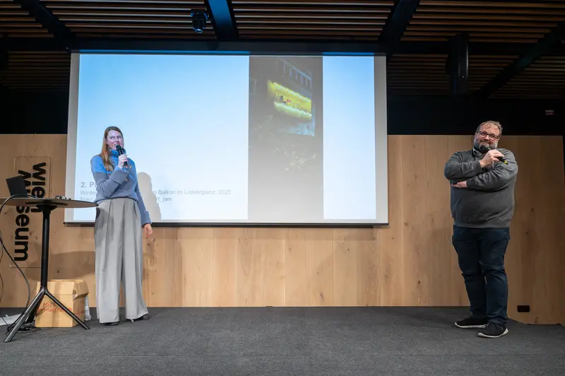 Two Speakers Presenting at Design Conference with Projection Screen