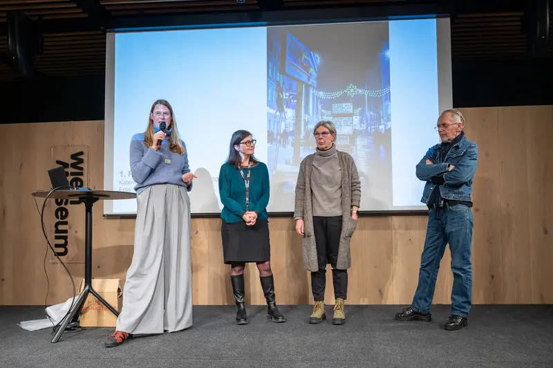 Design Panel Discussion at Museum Venue with City Projection Backdrop