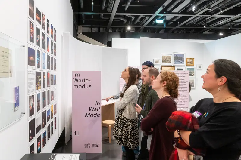 Visitors Exploring "In Wait Mode" Exhibition Gallery Space