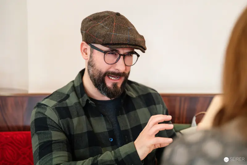 Falk Holzapfel in Animated Conversation at Cafe Museum, Vienna