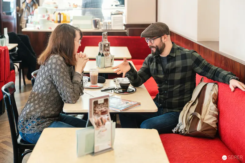 Falk Holzapfel and Janett Cernohuby Discussing at Cafe Museum in Vienna