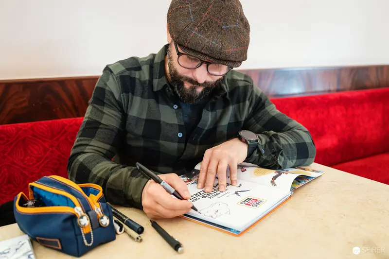Designer Working on Illustration at Cafe Museum in Vienna