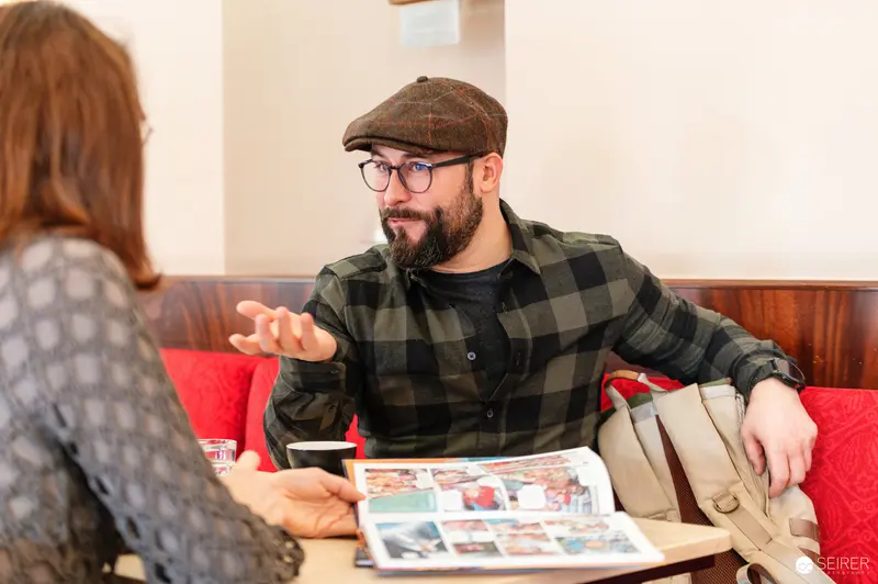 Falk Holzapfel "Zapf" and Janett Cernohuby Discussing at Cafe Museum, Vienna