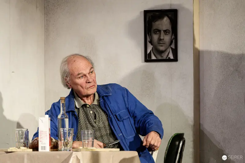 Older Man in Blue Jacket at Theater Rehearsal for "Azur oder die Farbe von Wasser"