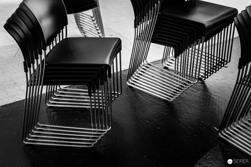 Black Stacking Chairs with Minimalist Chrome Wire Frame Design