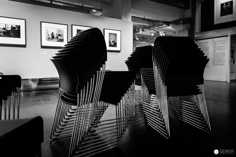 Stacked Chairs in Black and White Gallery Setting