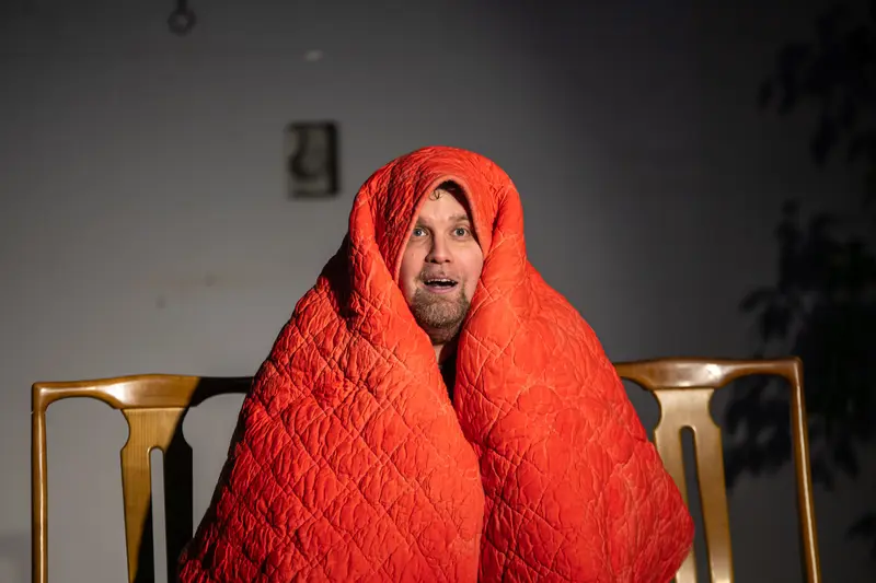 David Czifer Wrapped in Red Quilt During LINE RUNNER 2024 Performance