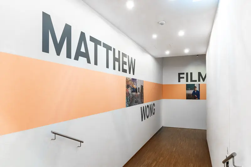 Matthew Wong Film Exhibition Interior with Geometric Orange and White Design