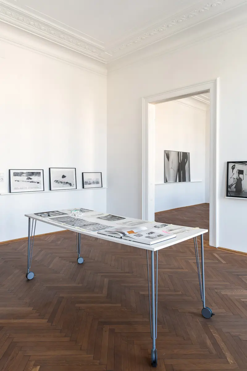 Art Exhibition Installation with Photographs and Mobile Table in Gallery Space